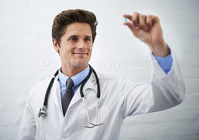 Buy stock photo Happy man, doctor and checking pill for healthcare, cure or drugs on a white studio background or wall. Male person, surgeon or medical nurse looking at medication in research, study or examination