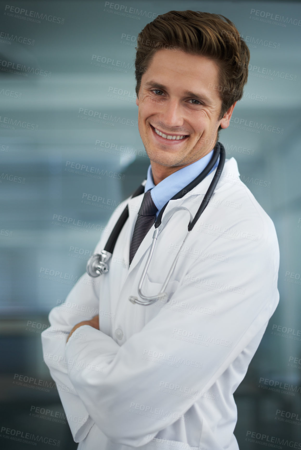 Buy stock photo Smile, crossed arms and portrait of man doctor with stethoscope for positive, good and confident attitude. Happy, pride and young male healthcare worker in medical office of hospital or clinic.