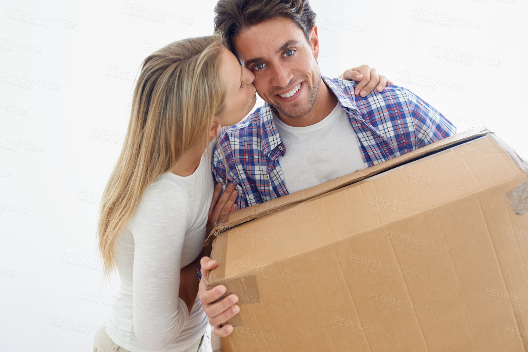 Buy stock photo Couple, boxes and happy with kiss for real estate, new home or property investment with romance or love. Moving, man and woman with smile, hug or embrace for fresh start, achievement and dream house