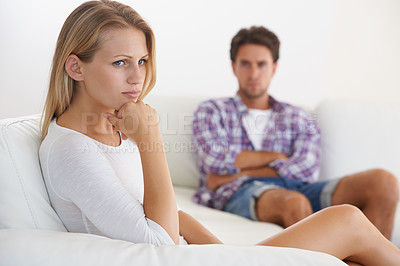 Buy stock photo Couple, angry and living room couch with disagreement, upset and thinking with anger, fight or mad. Divorce, betrayal and relationship with cheating, stress and argument for marriage, home or toxic