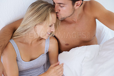 Buy stock photo Above, bedroom or happy couple kiss on holiday vacation or romantic honeymoon to celebrate marriage. Morning, love or people hug to cuddle in home, house or hotel together with romance, bond or care