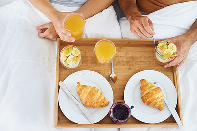 Buy stock photo Couple, food and breakfast in bed for morning, wakeup or meat and snack together in relax at home. Top view of man and woman hands eating healthy for diet, nutrition or vitamin c juice in bedroom