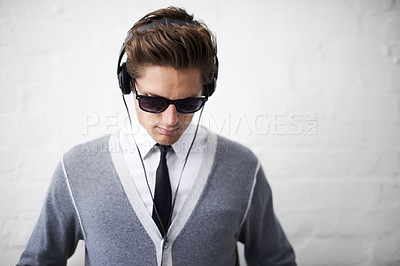 Buy stock photo Man, headphones and listening to song and relaxing to music by wall background, sound and peace. Male person, meditation and streaming radio or podcast, playlist and hearing audio and wellness
