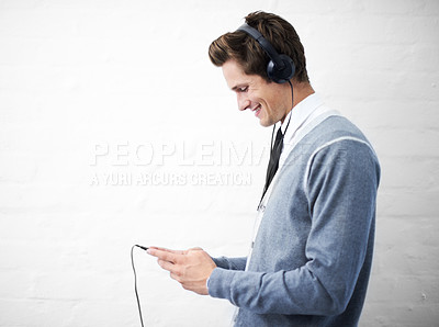 Buy stock photo A young nerdy guy holding an mp3 player