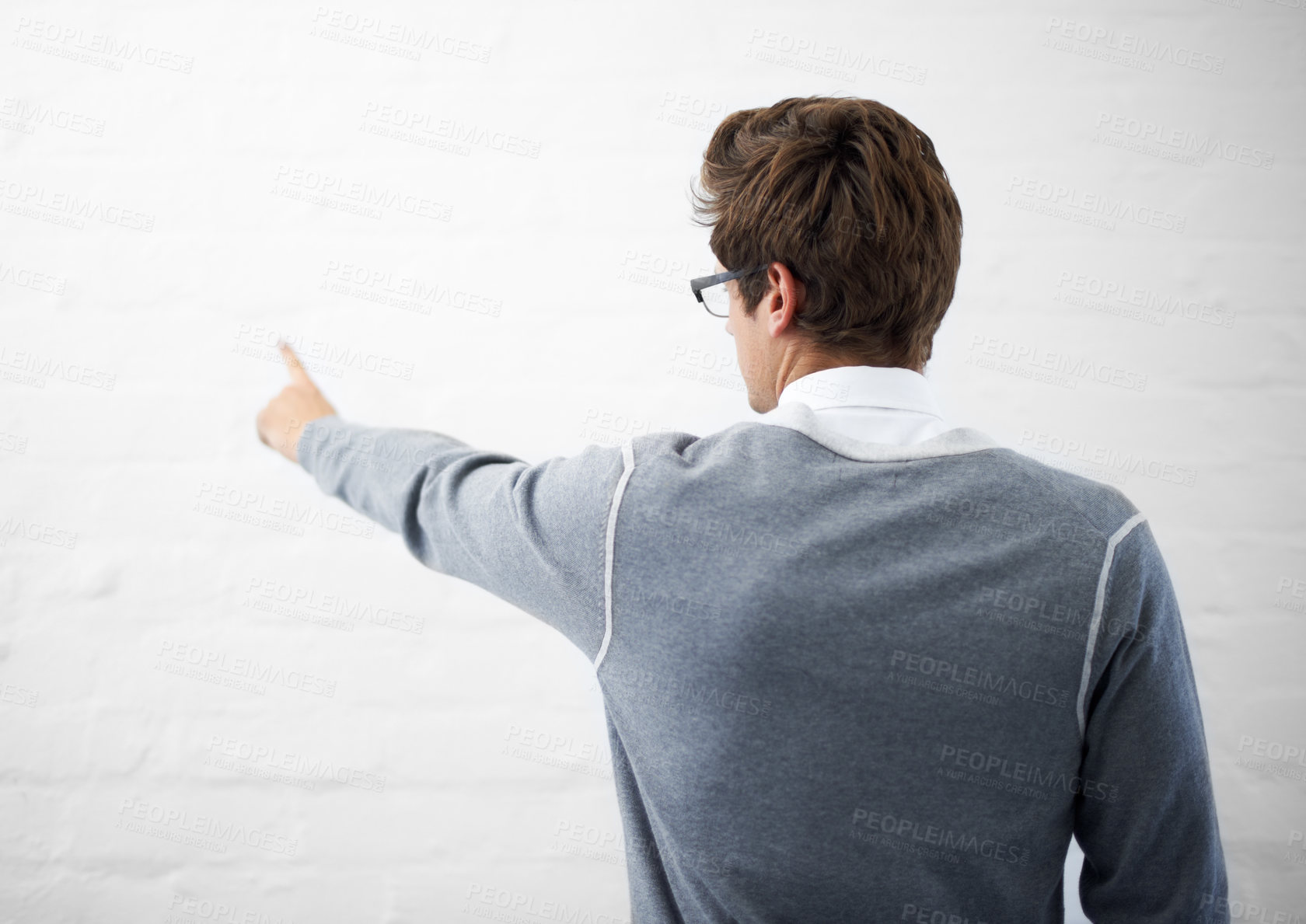 Buy stock photo Man, back and pointing to mockup space by wall background, presentation and marketing or branding. Male person, advertising and product placement by backdrop, logo and sign or showing decision