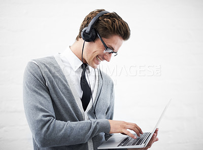 Buy stock photo Happy man, laptop and headphones listening to music, audio or streaming on a gray studio background. Male person, nerd or geek smile with computer and headset for sound or podcast on mockup space