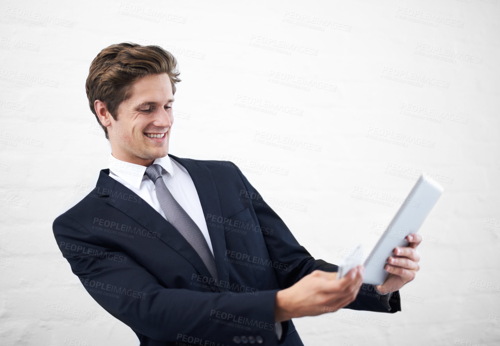 Buy stock photo Happy businessman, tablet and phone for communication, research or social media on a white studio background. Man or employee in business fashion with mobile smartphone and technology on mockup space