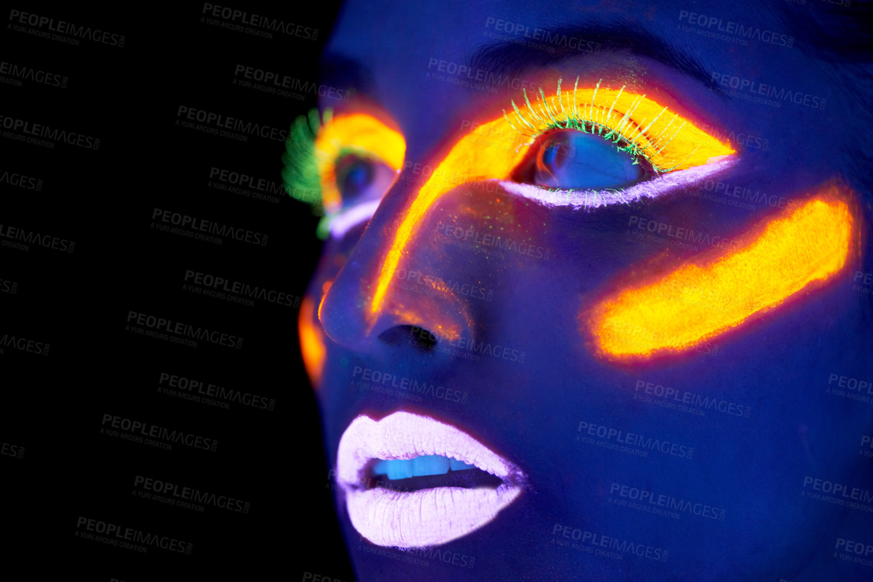 Buy stock photo A young woman with with neon paint on her face posing