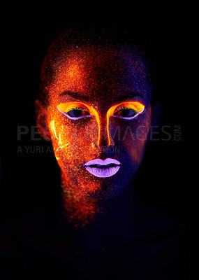 Buy stock photo A young woman with with neon paint on her face posing