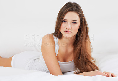 Buy stock photo Portrait of an attractive young woman lying in bed