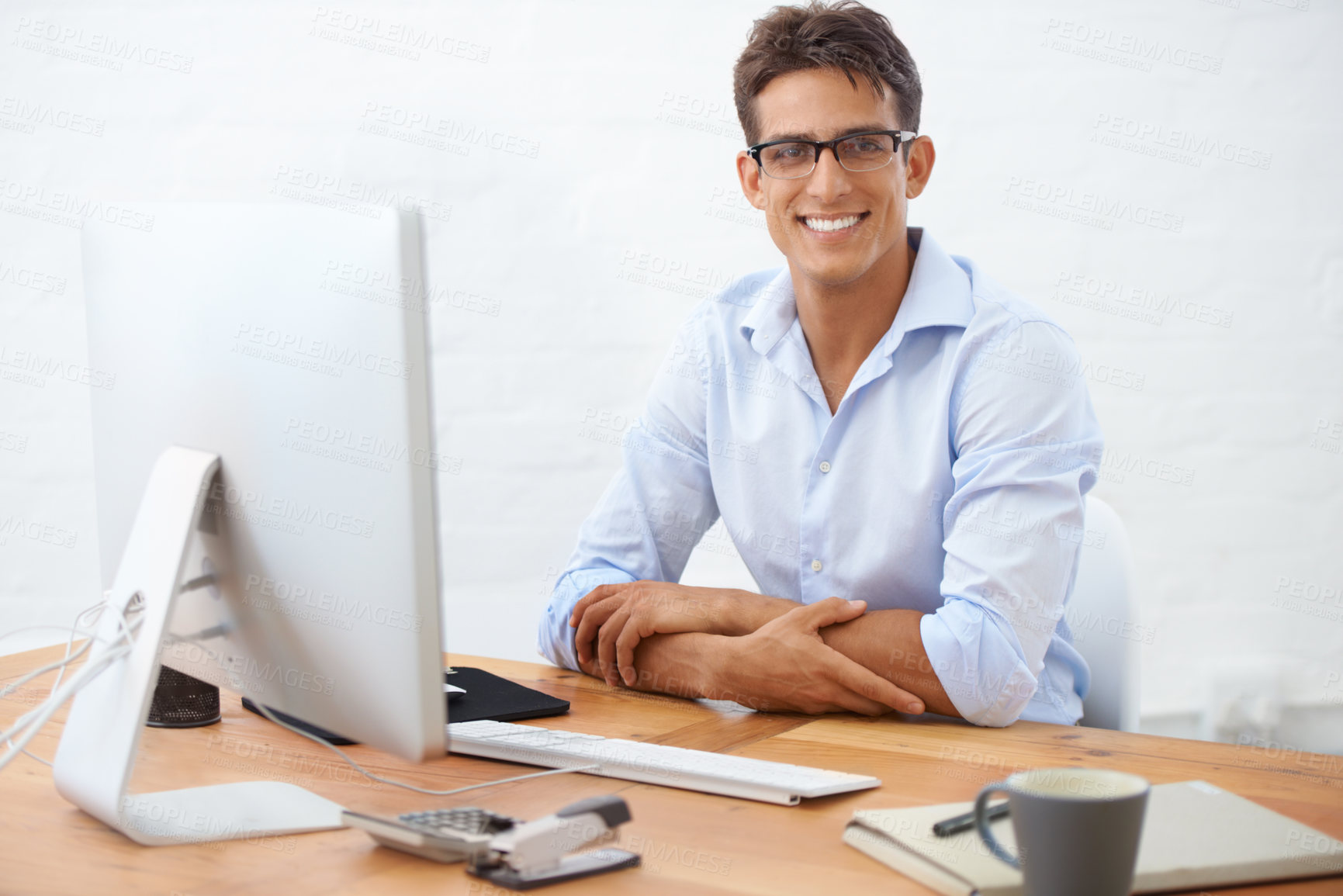 Buy stock photo Portrait of a smiling businessman sitting at his desk