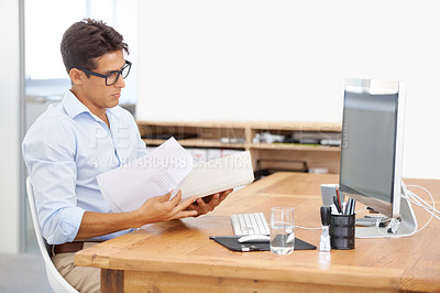 Buy stock photo Businessman, computer and reading documents in finance, budget planning or expenses at office. Man, accountant or employee checking paperwork for financial bills, invoice or payments at workplace