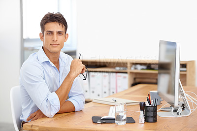 Buy stock photo Office, portrait or employee with computer at desk with technology for project or solution. IT support, business or serious man programming with glasses or research online at workplace or workspace