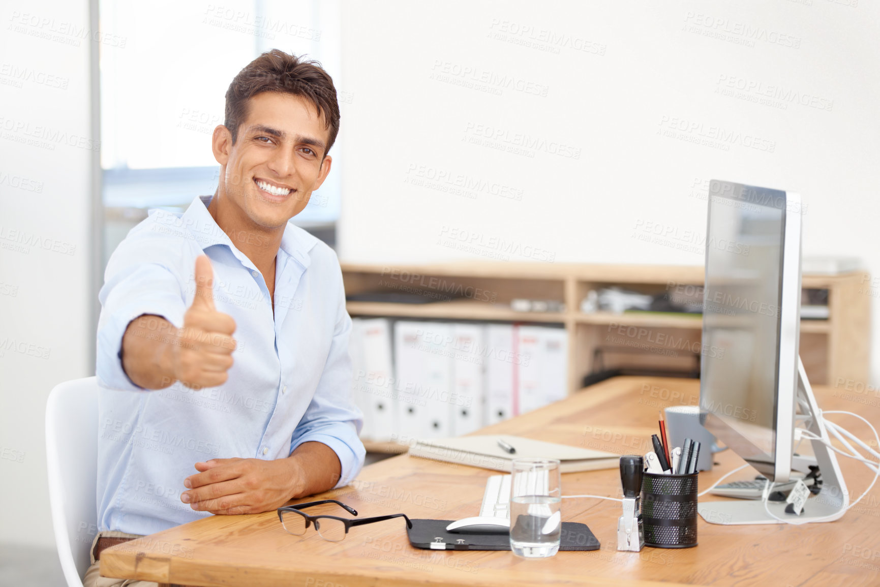 Buy stock photo Happy businessman, portrait and thumbs up at office for career success, winning or good job. Man or employee smile with like emoji, yes sign or OK for thank you or approval by computer at workplace