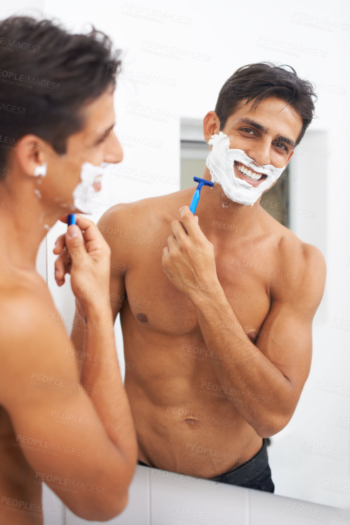 Buy stock photo A handsome young man shaving