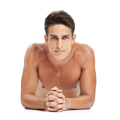 Buy stock photo A handsome young man lying against a white background