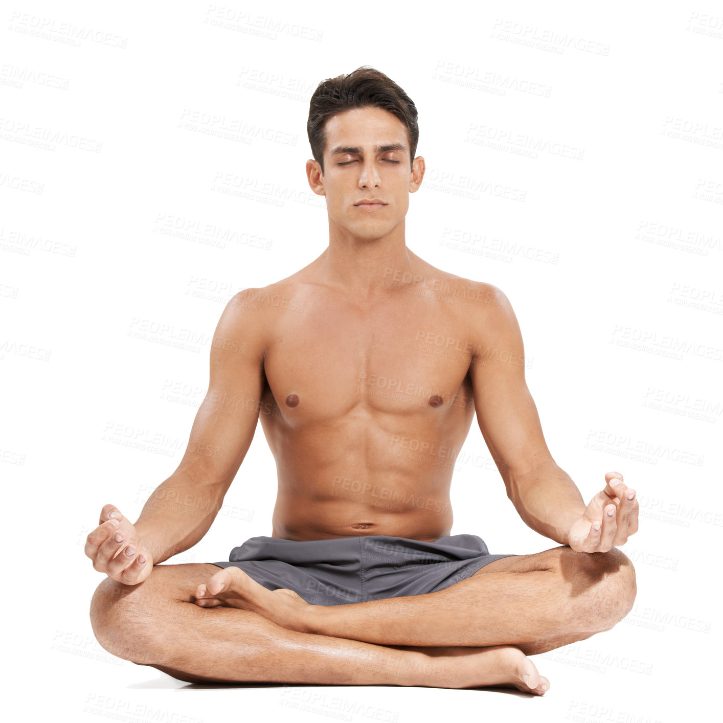 Buy stock photo A handsome young man doing yoga on a white background