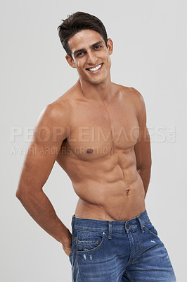 Buy stock photo Man, portrait and happy in studio for fashion, confidence and bodybuilder in jeans for style. Male person, shirtless and fitness or muscle progress, face and body care or wellness by gray background