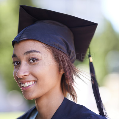 Buy stock photo Woman, portrait with graduate and achievement with education, cap and gown for ceremony outdoor. College, smile and graduation event for academic success, higher learning and certification with pride