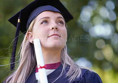 Buy stock photo A female graduate holding her diploma