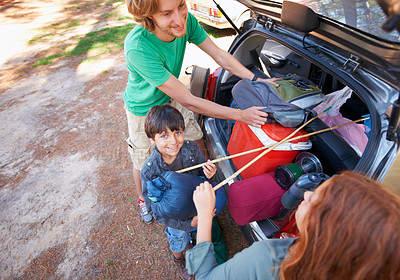 Buy stock photo Happy family, road trip and packing car trunk for camping, holiday or vacation above in nature outdoors. Top view of dad or kids getting ready for travel, camp adventure or getaway together in forest