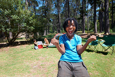 Buy stock photo Boy kid, cheers outdoor and fun at summer camp, happiness and celebration with smile in portrait. African kid in nature, adventure with winner in park with playful youth camper in forest and excited