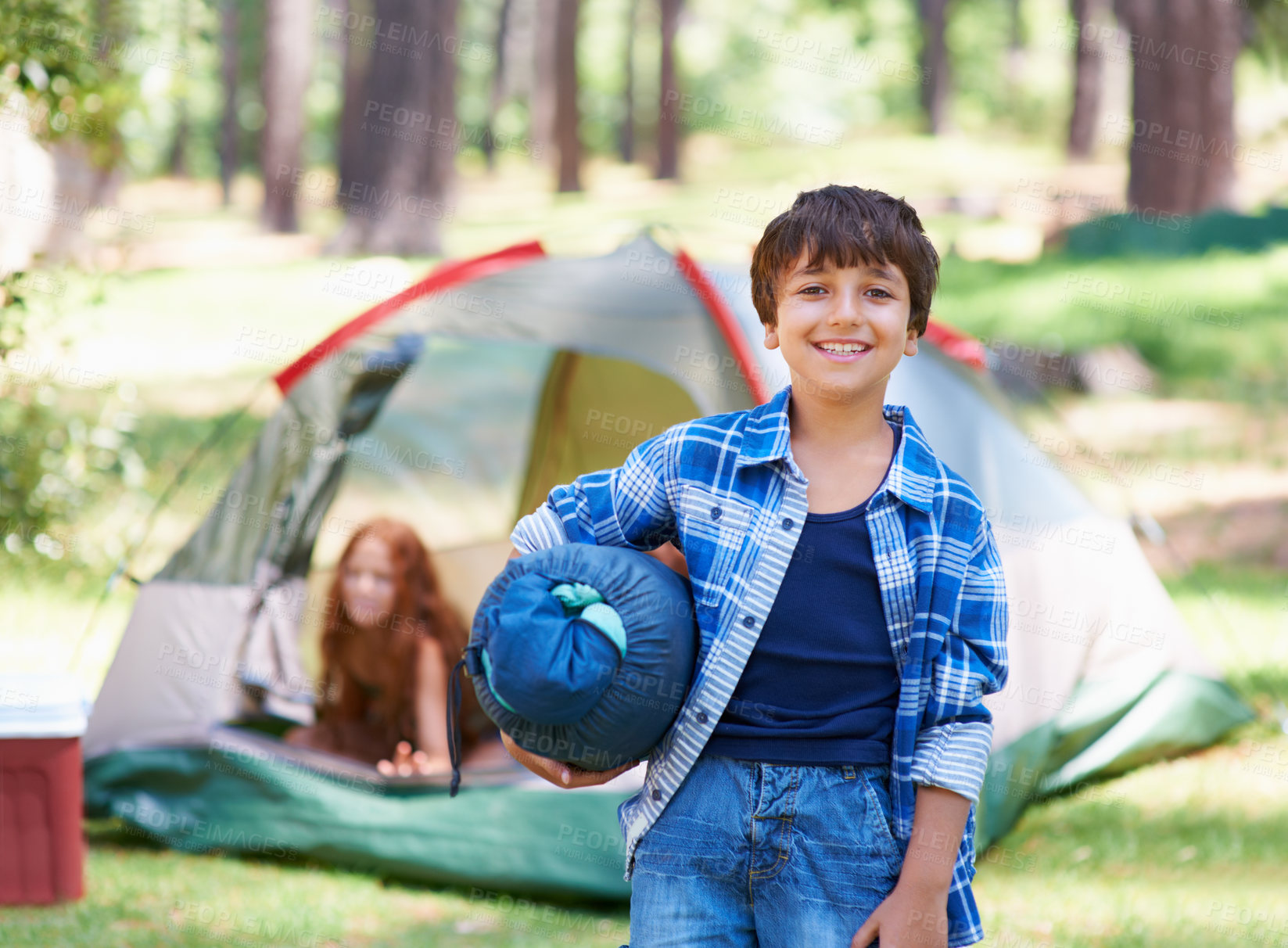 Buy stock photo Sleeping bag, camping or portrait of happy kid in park for adventure or holiday vacation in nature. Relax, start or boy with smile in woods, garden or forest ready for fun hiking, travel or wellness