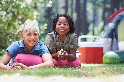 Buy stock photo Camping, children and relaxing in portrait on grass, bonding and happy for outdoor adventure. Kids, face and smiling together on holiday, friendship and vacation in nature, relaxing and ground