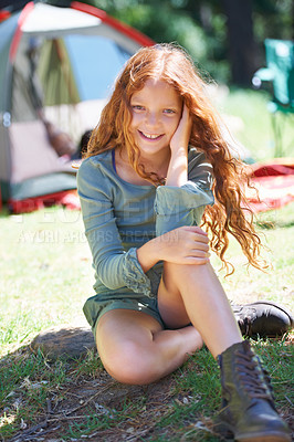 Buy stock photo Shot of a young girl sitting in front of her campsite