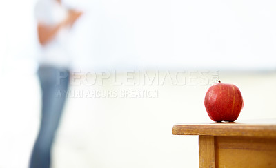 Buy stock photo Red apple, teacher and desk in classroom for natural diet, snack or nutrition with fiber on table. Closeup of fresh organic fruit or food for eating, health and wellness on mockup space at school