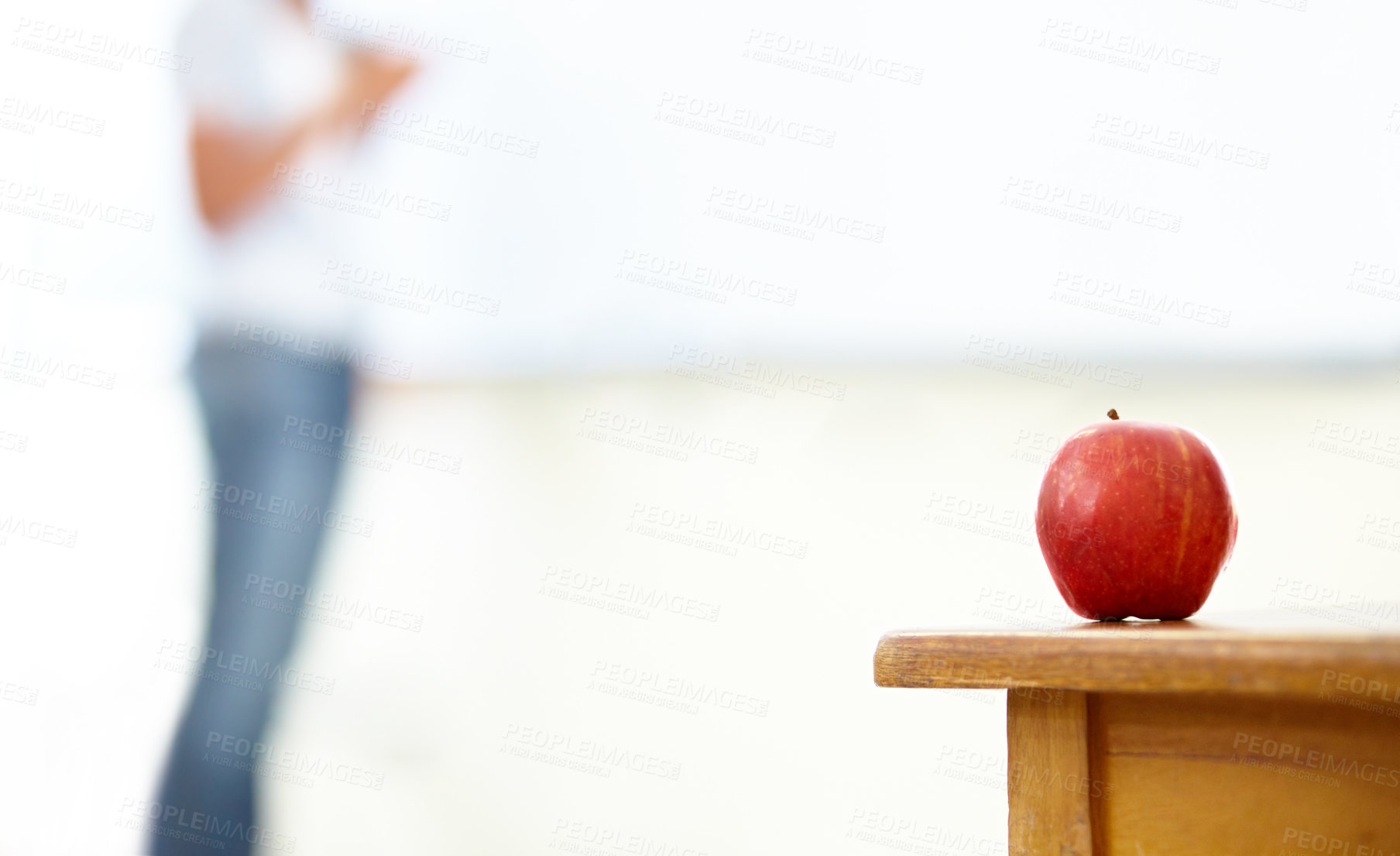 Buy stock photo Red apple, teacher and desk in classroom for natural diet, snack or nutrition with fiber on table. Closeup of fresh organic fruit or food for eating, health and wellness on mockup space at school