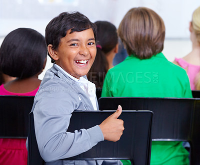 Buy stock photo Happy student, portrait and boy with thumbs up in class for winning, good job or success at school. Young male person, child or kid smile with like emoji, yes sign or OK for education in classroom