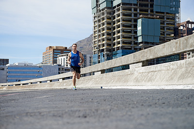 Buy stock photo Man is running on bridge, fitness and cardio outdoor for health and training for marathon. Exercise in city, runner with speed and energy, sports and athlete on urban street for race and endurance