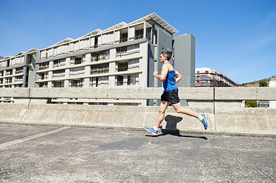 Buy stock photo Man is running on bridge, exercise and cardio outdoor for health and training for marathon. Fitness in city, runner with speed and energy, sports and athlete on urban street for race and endurance