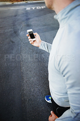 Buy stock photo Man, runner and fitness progress on phone on street, screen and exercise or training for marathon. Male person, athlete and workout by city background, mobile app and performance challenge or timer