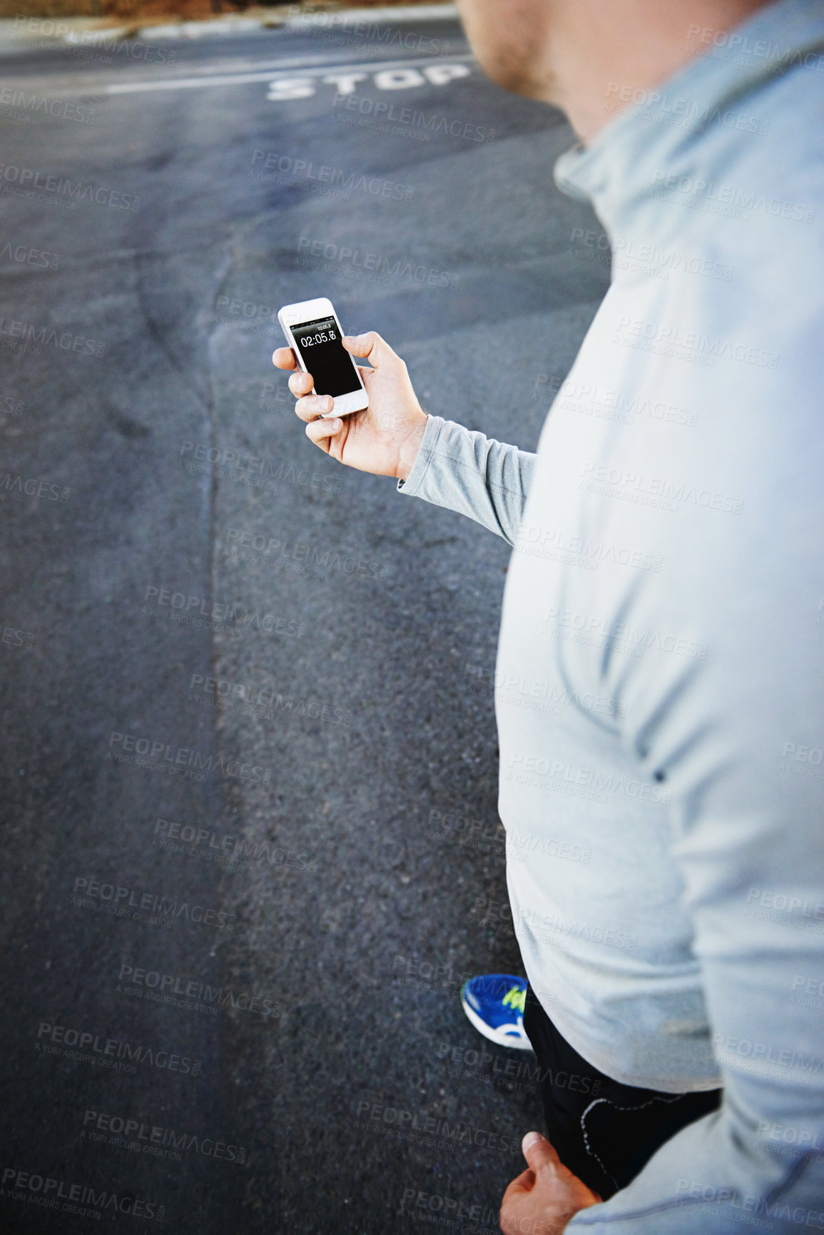 Buy stock photo Man, runner and fitness progress on phone on street, screen and exercise or training for marathon. Male person, athlete and workout by city background, mobile app and performance challenge or timer