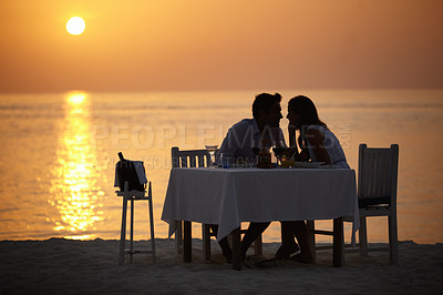 Buy stock photo Love, ocean sunset and couple at table for romantic valentines day date at the beach in Bali in silhouette. Romance, food and wine on vacation for man and woman in loving relationship in Indonesia