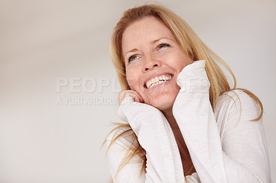 Buy stock photo Happy woman, smiling and playful with hands on face, morning and alone in home, natural beauty. Female, beautiful and thinking with idea, mature person and cheerful lady in house or blonde hair