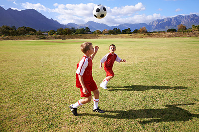 Buy stock photo Children, exercise and playing soccer on field, practice and training for match and game in outdoors. People, kids and fitness or cardio and sports, ball and sportswear or workout together for fun