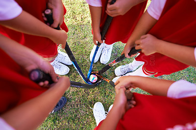 Buy stock photo Children, hockey team and circle above with ball on green grass for sports, match or game together. Top view closeup of kids, player hands and huddle on field for teamwork or outdoor unity in nature