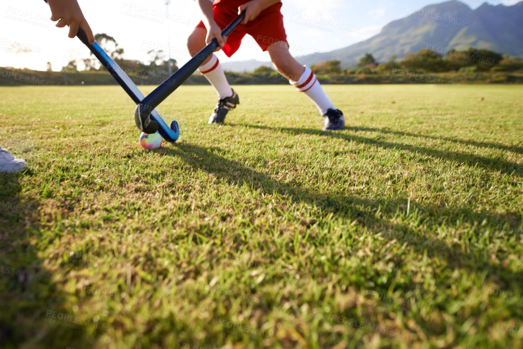 Buy stock photo Children, ball and playing hockey on field for game, sports or outdoor match together. Team, kids or players in competition on green grass for tackle, practice or training in fitness or nature