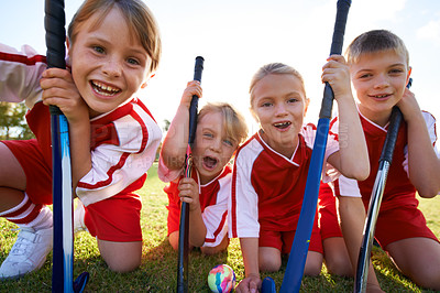 Buy stock photo Portrait of happy children playing field hockey