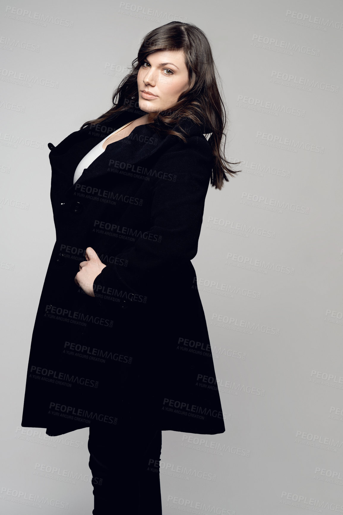 Buy stock photo Woman, fashion and portrait of plus size model posing in winter clothing against grey studio background. Isolated female person standing with stylish black coat or warm fashionable clothes for beauty