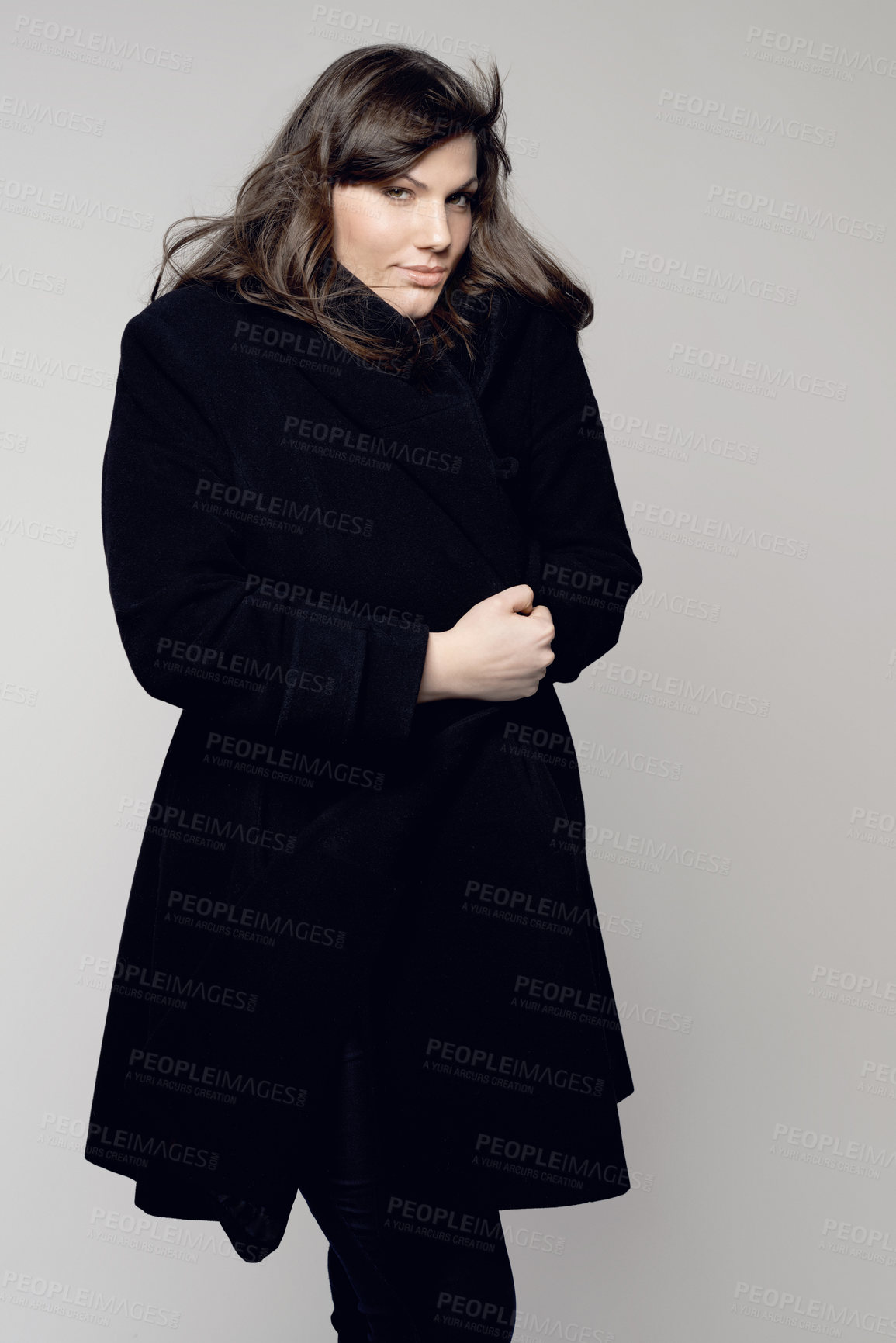 Buy stock photo Woman, fashion and portrait of plus size model posing in winter clothing against a grey studio background. Isolated female person standing with stylish black coat, body or warm fashionable clothes