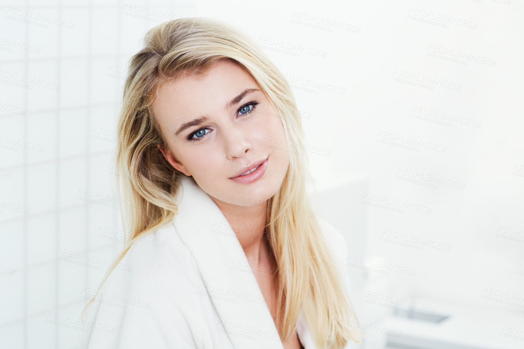 Buy stock photo A beautiful young woman in her bathrobe sitting in the bathroom