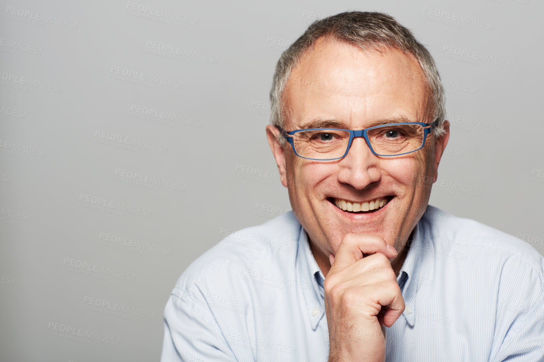 Buy stock photo Senior man, portrait and smile in studio with happiness, pride and confident by gray background. Elderly guy, happy and excited face for experience, knowledge and retirement by backdrop with glasses