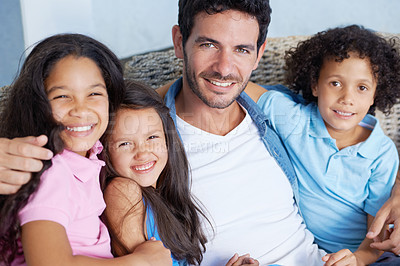 Buy stock photo Portrait of a happy single parent family sitting on a sofa and smiling at the camera