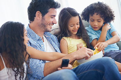 Buy stock photo Happy family, relax father and children with food, eating meal and hungry while watching tv, film or home entertainment. Bonding, snack and youth kids, dad or group enjoy quality time together
