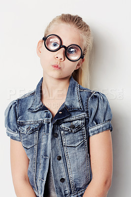 Buy stock photo Portrait of a young girl wearing big round glasses posing in the studio