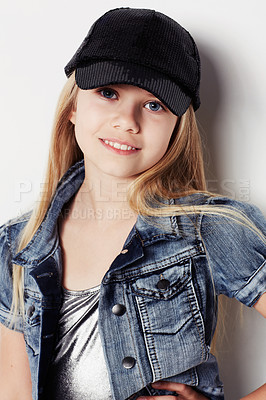 Buy stock photo Child, portrait and fashion in studio, confident and cool by white background. Female person, girl and casual clothing or style by backdrop, kid and denim jacket pride or smiling for trendy cap